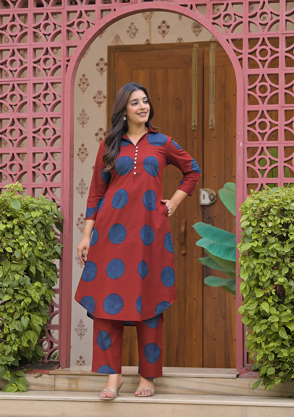 Front view of woman wearing Rust Orbit rust red and indigo blue printed cotton kurta set