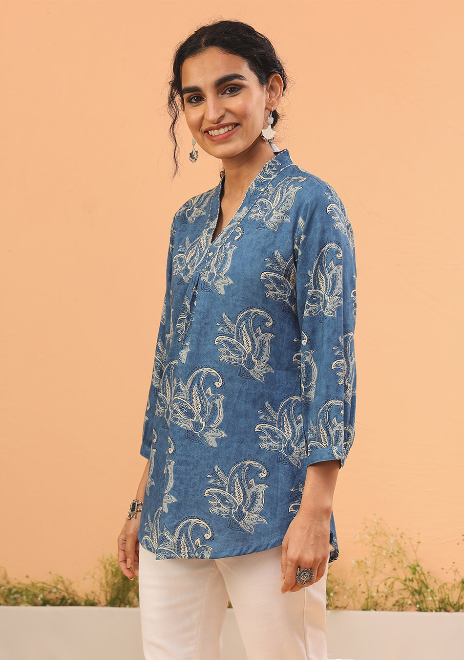 Woman wearing indigo mandarin collar top with 3/4 sleeves