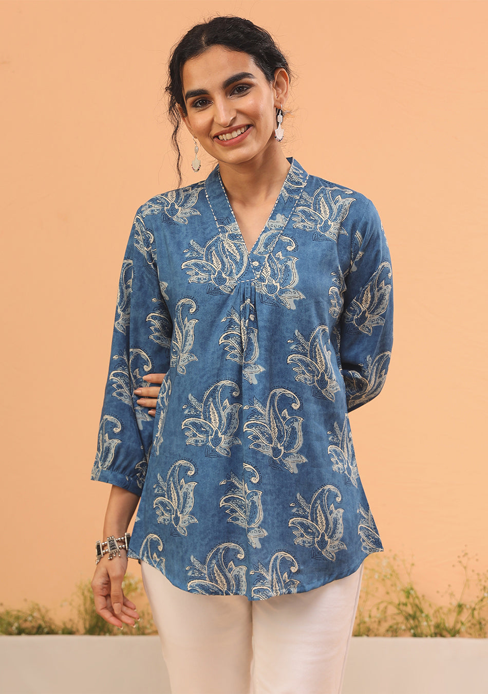 Close-up of indigo botanical print and pleated detailing on cotton-modal top