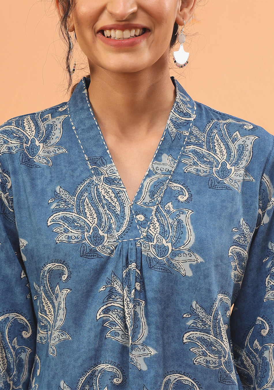 closure detail on indigo pleated top
