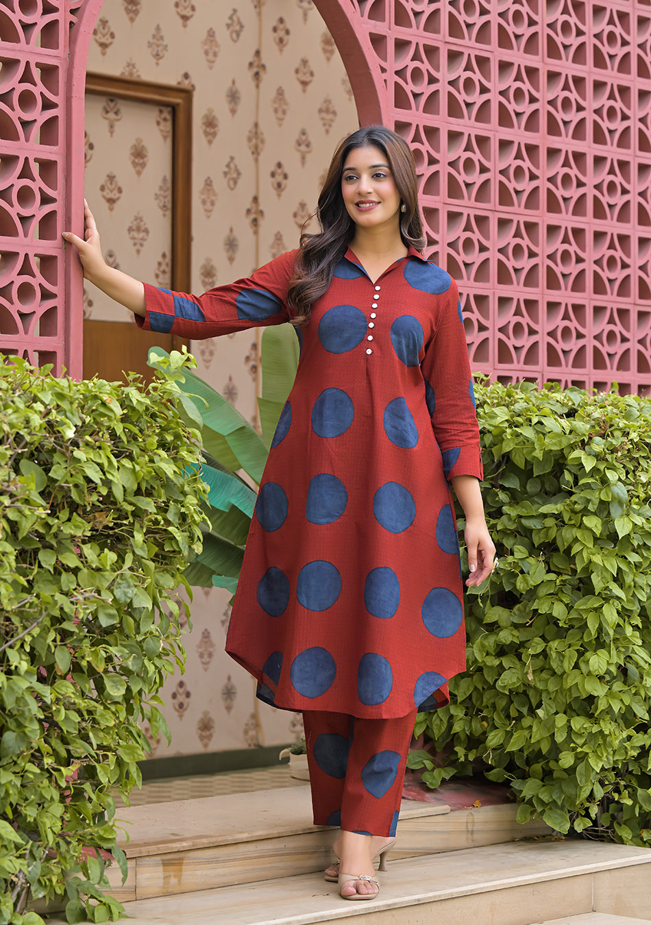 Front view of woman wearing Rust Orbit rust red and indigo blue printed cotton kurta set